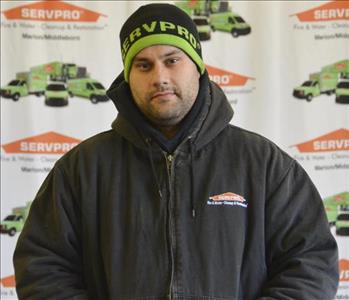 Crew Chief Josh poses in front of our SERVPRO backdrop